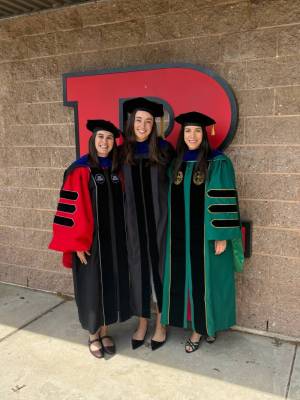 Three members of the REHAB Lab in regalia